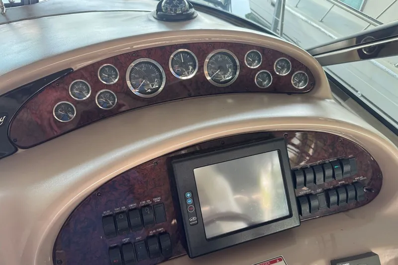 Slide: The Image of Dashboard of a 2003 Sea Ray 410 Sundancer with gauges and control panel. - 29