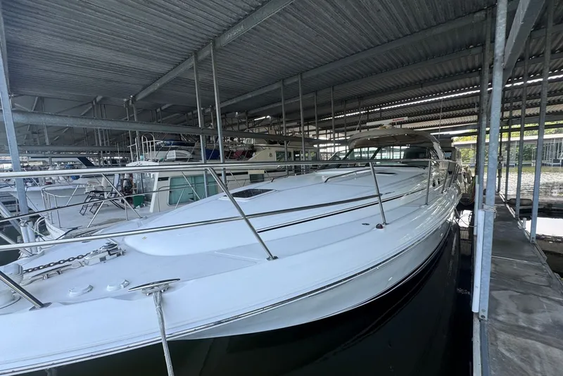 Slide: The Image of 2003 Sea Ray 410 Sundancer yacht docked in a covered marina. - 6
