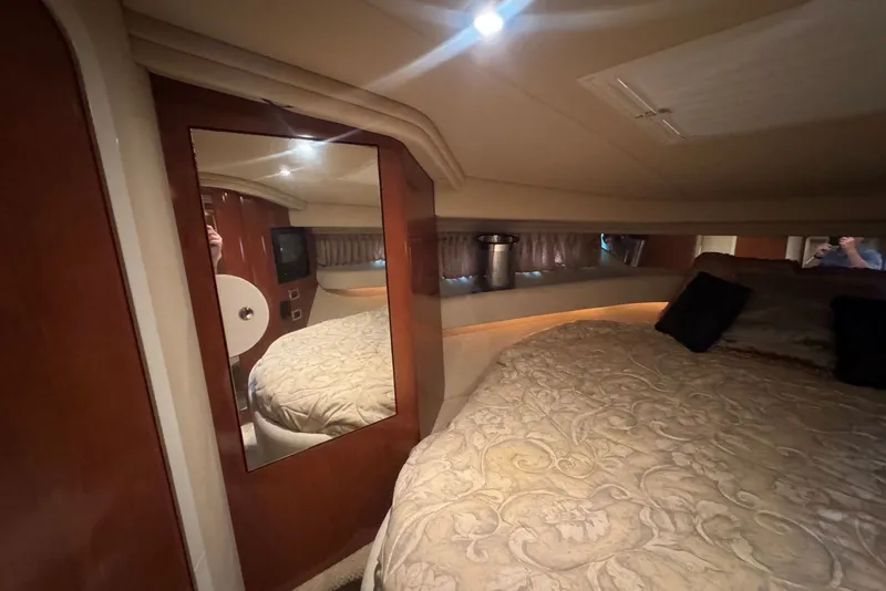 Slide: The Image of Luxurious cabin interior of 2003 Sea Ray 410 Sundancer yacht with elegant bedding and wood finishes. - 42
