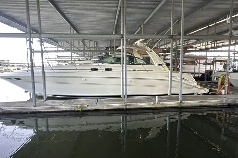 Slide: The Image of 2003 Sea Ray 410 Sundancer yacht docked in a covered marina. - 2