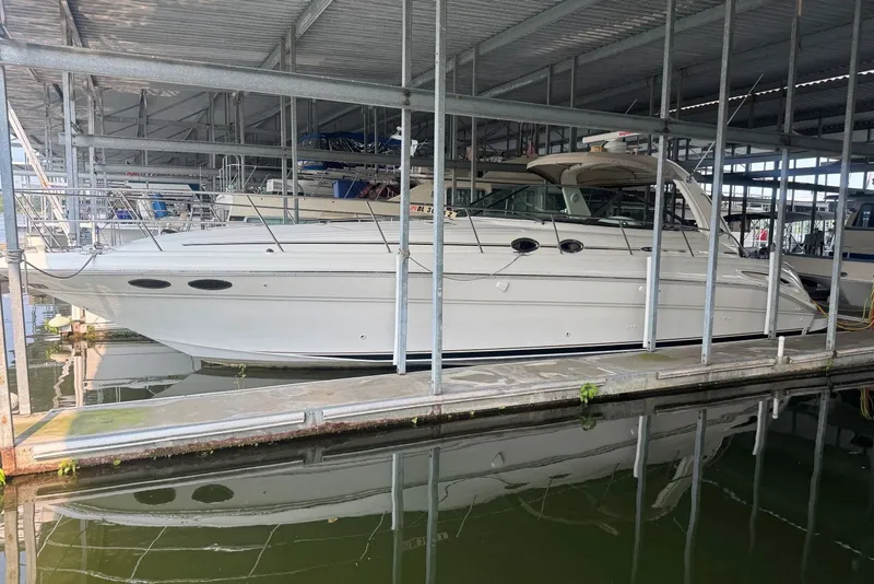 The Image of 2003 Sea Ray 410 Sundancer yacht docked in a covered marina. - 0