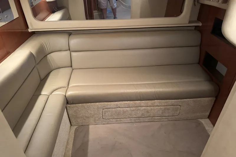 Slide: The Image of Interior of 2003 Sea Ray 410 Sundancer with beige leather seating and wood accents. - 49