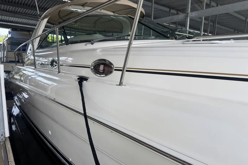 Slide: The Image of 2003 Sea Ray 410 Sundancer yacht docked in a covered marina. - 11