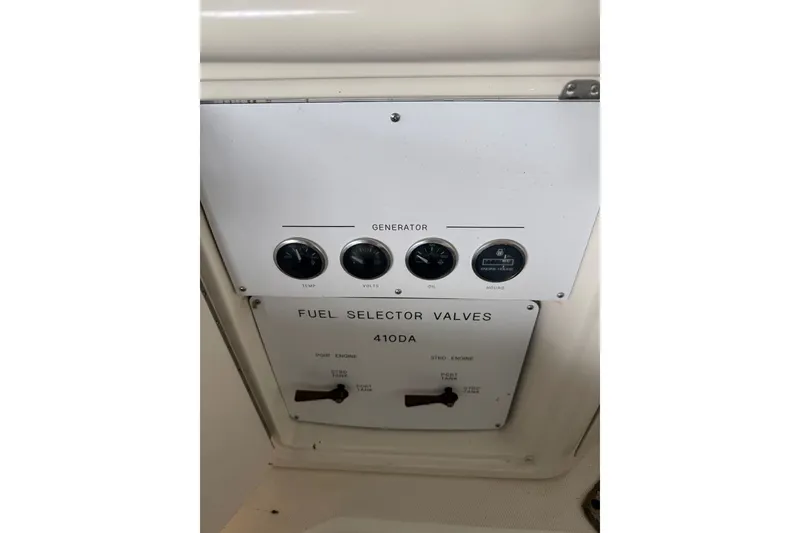 Slide: The Image of Control panel of a 2003 Sea Ray 410 Sundancer with fuel selector valves. - 21