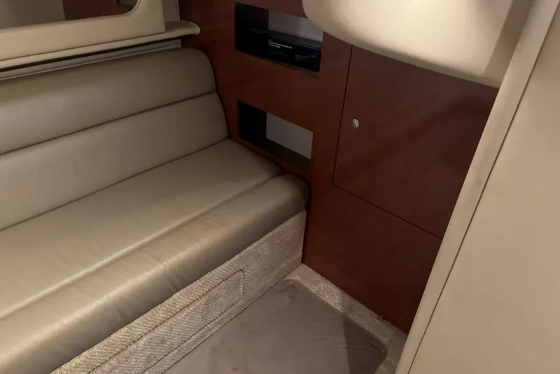 Slide: The Image of Interior of 2003 Sea Ray 410 Sundancer with beige seating and wooden cabinetry. - 50