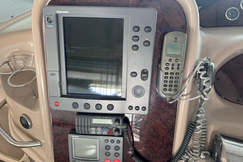 Slide: The Image of Control panel of a 2003 Sea Ray 410 Sundancer with navigation and communication equipment. - 28