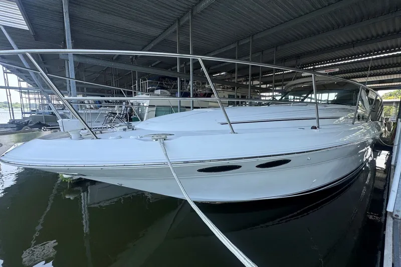 Slide: The Image of 2003 Sea Ray 410 Sundancer yacht docked in a covered marina. - 5