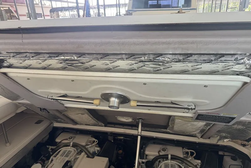 Slide: The Image of Engine compartment of a 2003 Sea Ray 410 Sundancer boat, showing mechanical components. - 63