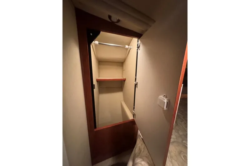 Slide: The Image of Interior closet of 2003 Sea Ray 410 Sundancer yacht with wooden shelving. - 43
