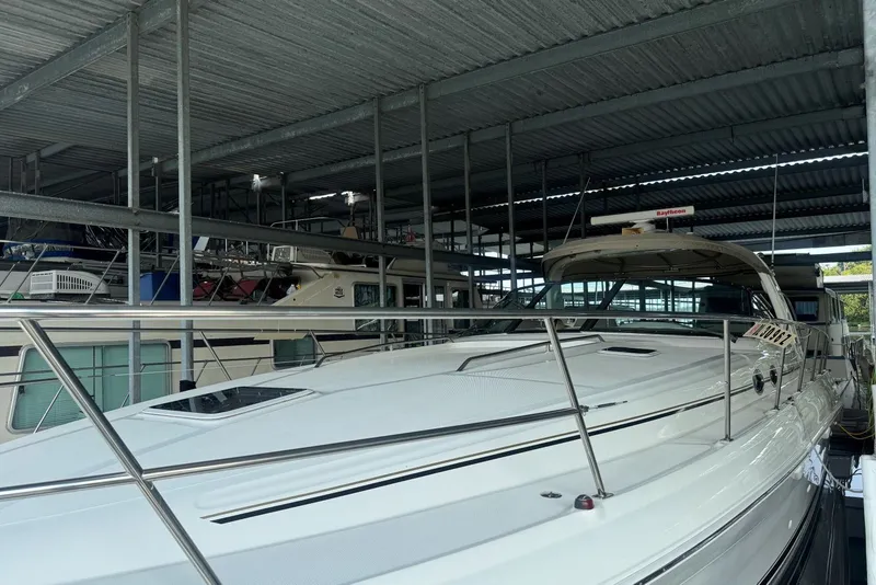 Slide: The Image of 2003 Sea Ray 410 Sundancer yacht docked in a covered marina. - 4