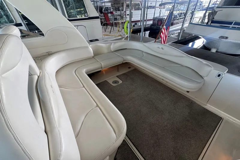 Slide: The Image of Luxurious seating area on a 2003 Sea Ray 410 Sundancer yacht, docked with American flag. - 23