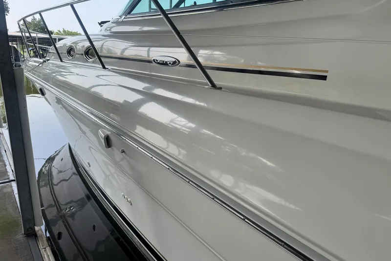 Slide: The Image of 2003 Sea Ray 410 Sundancer yacht docked, showcasing sleek white exterior and elegant design. - 8
