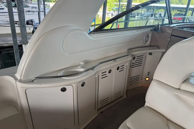 Slide: The Image of Interior view of a 2003 Sea Ray 410 Sundancer yacht, featuring sleek cabinetry and seating. - 20