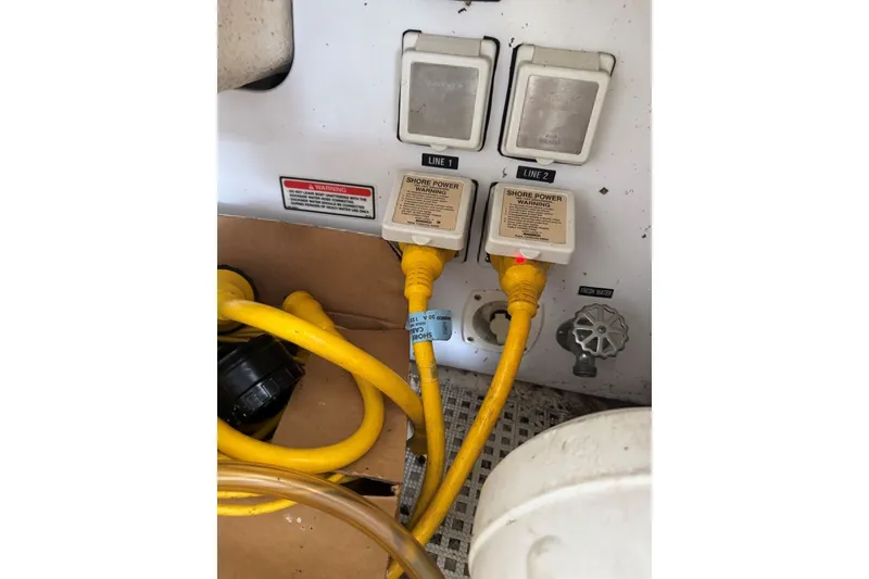 Slide: The Image of Shore power connections on a 2003 Sea Ray 410 Sundancer boat with yellow cables. - 64