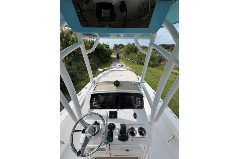 Slide: The Image of 2019 Sportsman Masters 227 Bay Boat cockpit with steering wheel and navigation controls. - 10