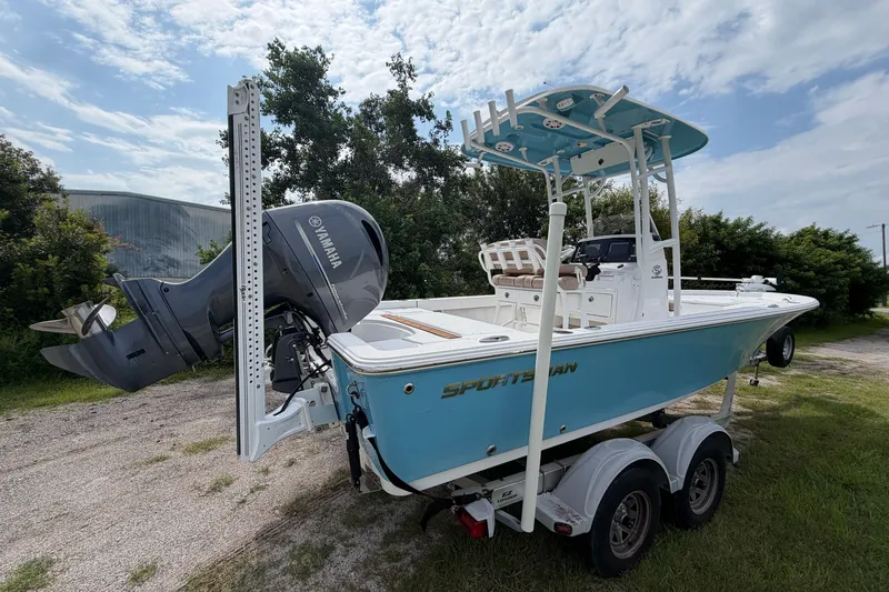 Slide: The Image of 2019 Sportsman Masters 227 Bay Boat with Yamaha engine on trailer, under cloudy sky. - 4