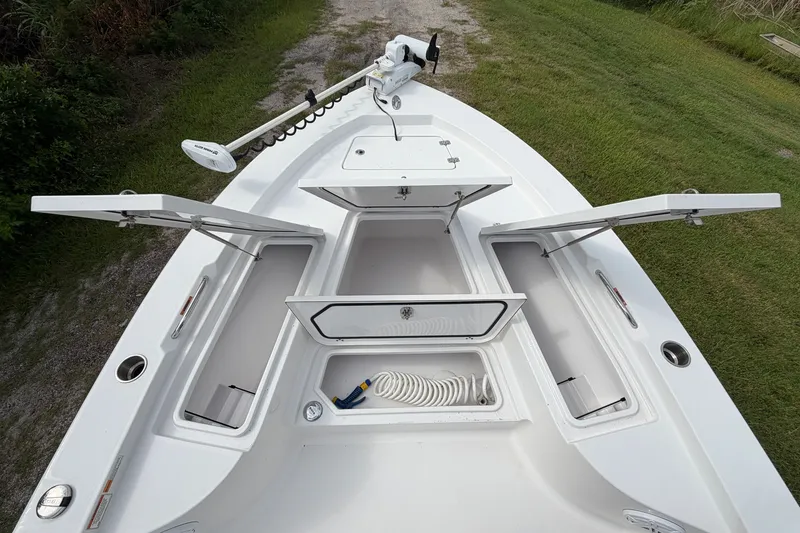 Slide: The Image of 2019 Sportsman Masters 227 Bay Boat with open storage compartments and trolling motor. - 6