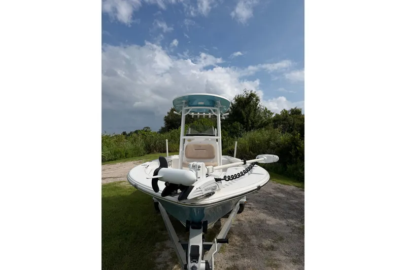 Slide: The Image of 2019 Sportsman Masters 227 Bay Boat on trailer, parked outdoors under a cloudy sky. - 1