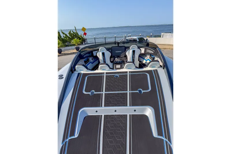 Slide: The Image of 2026 Doug Wright 36 boat interior with sleek design, overlooking a scenic waterfront. - 11