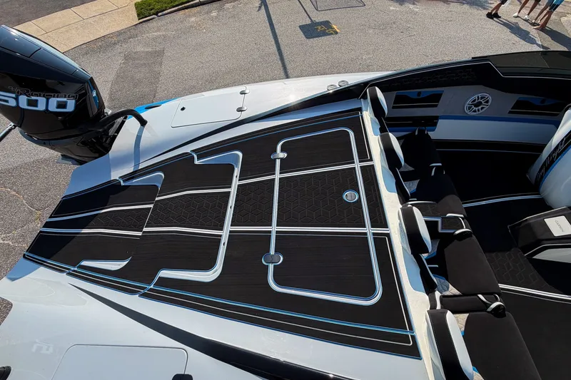 Slide: The Image of 2026 Doug Wright 36 boat interior with sleek black and blue design, featuring a powerful engine. - 10