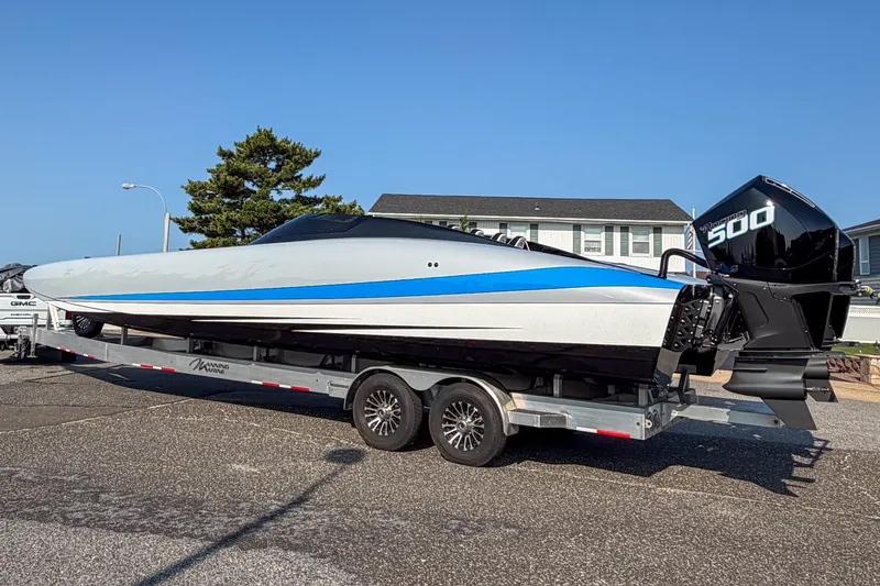 Slide: The Image of 2026 Doug Wright 36 powerboat on trailer, featuring sleek design and powerful outboard engine. - 1