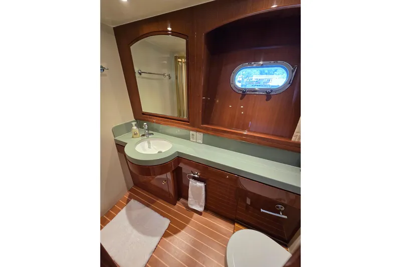 Slide: The Image of Luxurious 2004 Grand Harbour 58 yacht bathroom with wood accents and porthole window. - 50