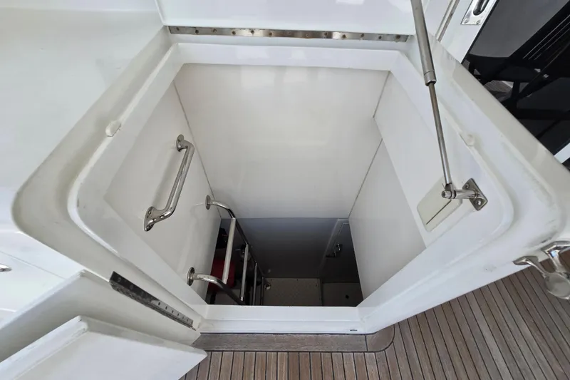 Slide: The Image of Hatch entrance with ladder on 2004 Grand Harbour 58 yacht, featuring stainless steel handles. - 133