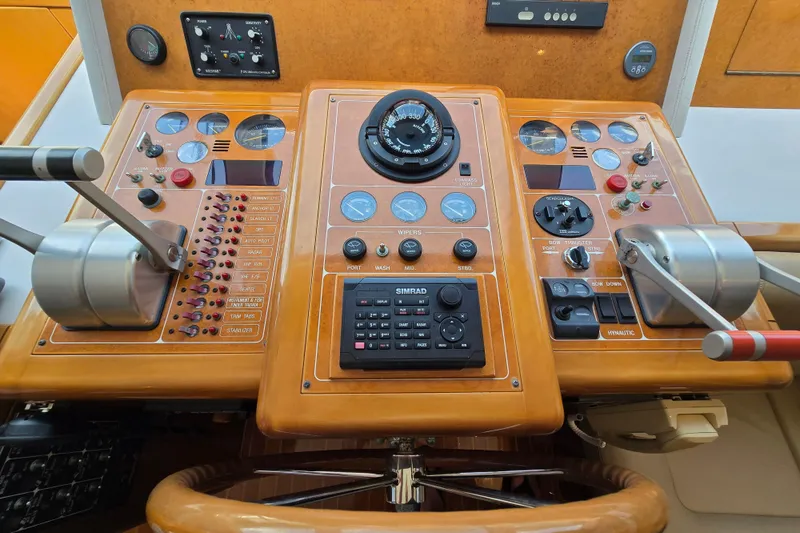 Slide: The Image of Control panel of a 2004 Grand Harbour 58 yacht, featuring navigation and throttle controls. - 29