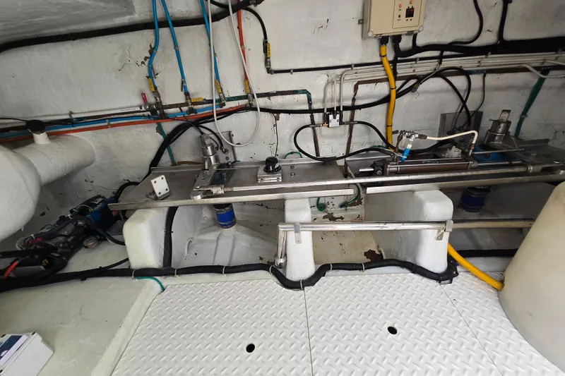 Slide: The Image of Engine room of a 2004 Grand Harbour 58 yacht, showcasing pipes and machinery. - 107