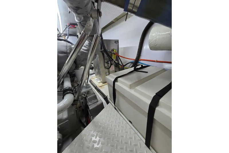 Slide: The Image of Engine room of 2004 Grand Harbour 58 yacht, featuring mechanical components and storage. - 123