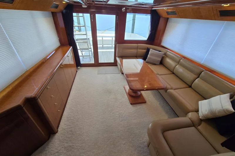 Slide: The Image of Luxurious interior of 2004 Grand Harbour 58 yacht with leather seating and wooden table. - 41