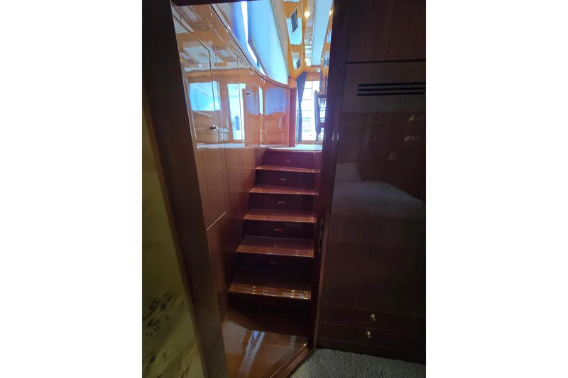 Slide: The Image of Interior wooden staircase on a 2004 Grand Harbour 58 yacht, leading to upper deck. - 58
