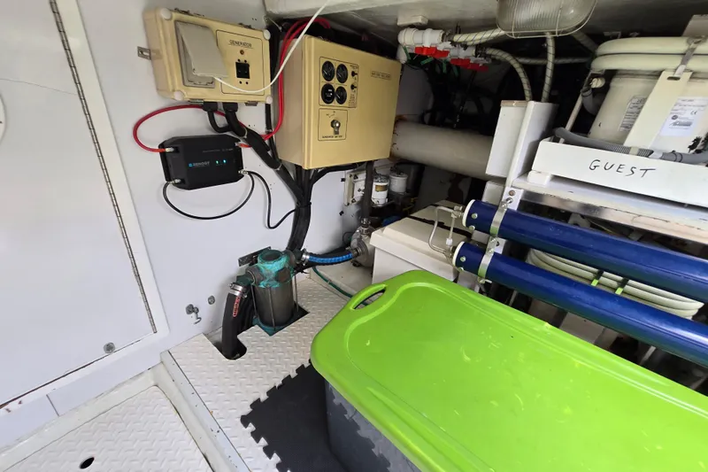 Slide: The Image of Engine room of a 2004 Grand Harbour 58 yacht with various equipment and storage. - 112