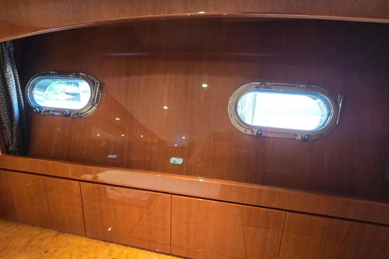 Slide: The Image of Luxurious wooden interior of 2004 Grand Harbour 58 yacht with two porthole windows. - 47