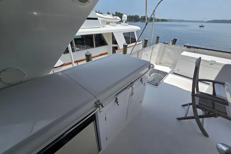 Slide: The Image of Deck view of 2004 Grand Harbour 58 yacht with seating and water backdrop. - 82