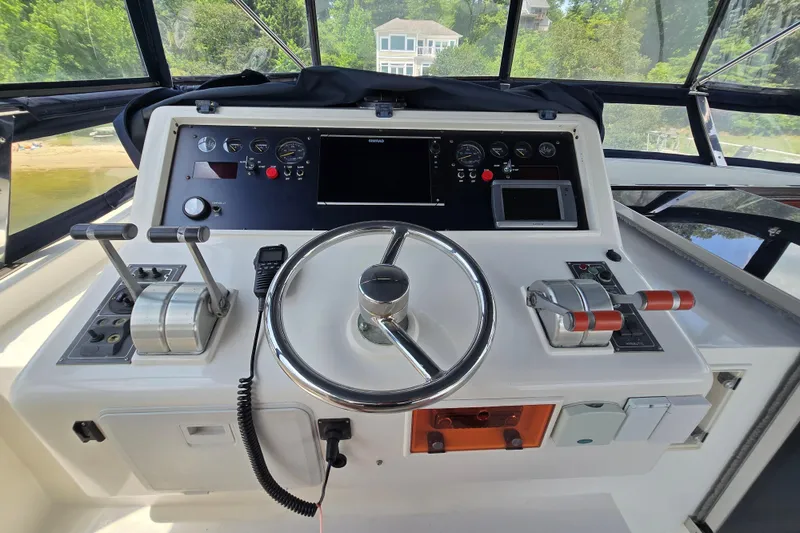 Slide: The Image of Helm of 2004 Grand Harbour 58 yacht with steering wheel and control panel. - 96
