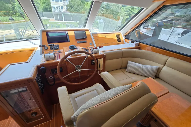 Slide: The Image of Luxurious 2004 Grand Harbour 58 yacht helm with leather seating and modern controls. - 22