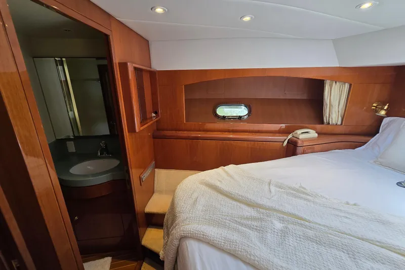 Slide: The Image of Luxurious 2004 Grand Harbour 58 yacht cabin with wood paneling and ensuite bathroom. - 68