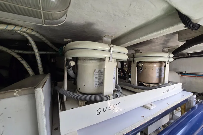 Slide: The Image of Engine room of 2004 Grand Harbour 58 yacht with labeled equipment and wiring. - 130