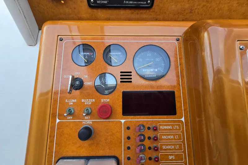 Slide: The Image of Control panel of a 2004 Grand Harbour 58 yacht with gauges and switches. - 27