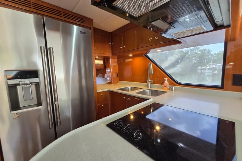 Slide: The Image of Luxurious yacht kitchen with stainless steel appliances, dual sinks, and modern fixtures, Grand Harbour 58, 2004. - 36