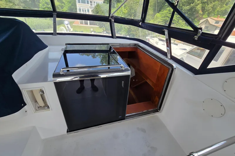 Slide: The Image of Interior view of a 2004 Grand Harbour 58 yacht with a mini fridge and wooden storage. - 89