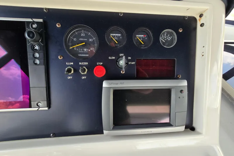 Slide: The Image of Control panel of a 2004 Grand Harbour 58 yacht with gauges and Garmin GPS. - 92