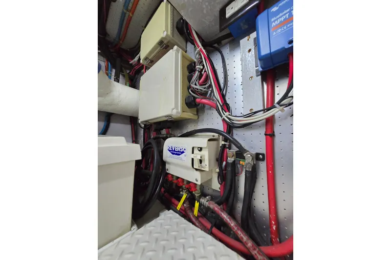 Slide: The Image of Electrical system inside a 2004 Grand Harbour 58 yacht, featuring wiring and control boxes. - 124