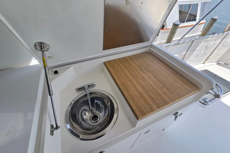 Slide: The Image of Outdoor sink and cutting board on 2004 Grand Harbour 58 yacht deck. - 84