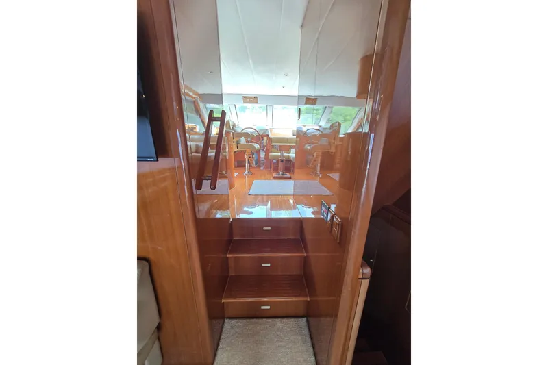 Slide: The Image of Interior view of 2004 Grand Harbour 58 yacht, featuring polished wooden stairs and elegant design. - 19
