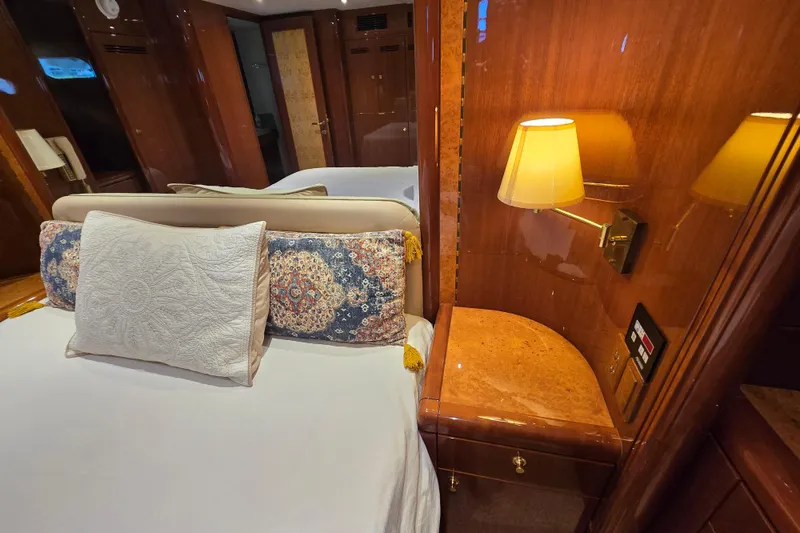 Slide: The Image of Luxurious 2004 Grand Harbour 58 yacht bedroom with elegant wood paneling and ambient lighting. - 57