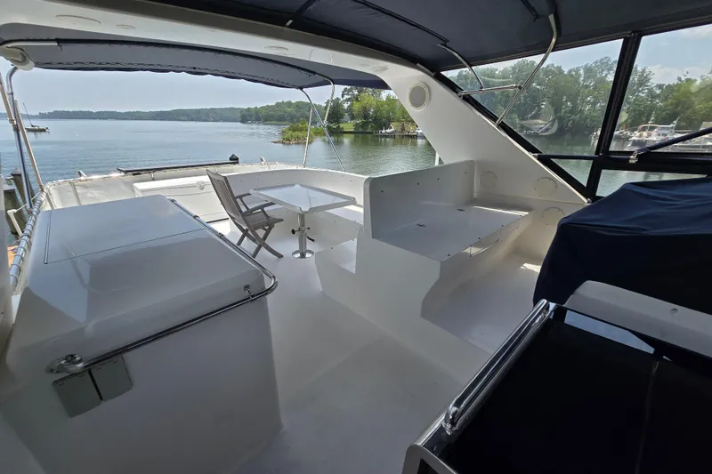 Slide: The Image of Luxurious 2004 Grand Harbour 58 yacht interior with seating and scenic waterfront view. - 79