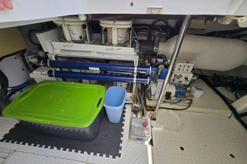 Slide: The Image of Engine room of 2004 Grand Harbour 58 yacht with equipment and storage containers. - 102