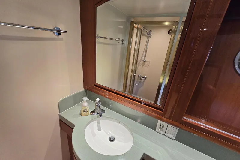 Slide: The Image of Luxurious bathroom in 2004 Grand Harbour 58 yacht with modern fixtures and elegant wood cabinetry. - 55